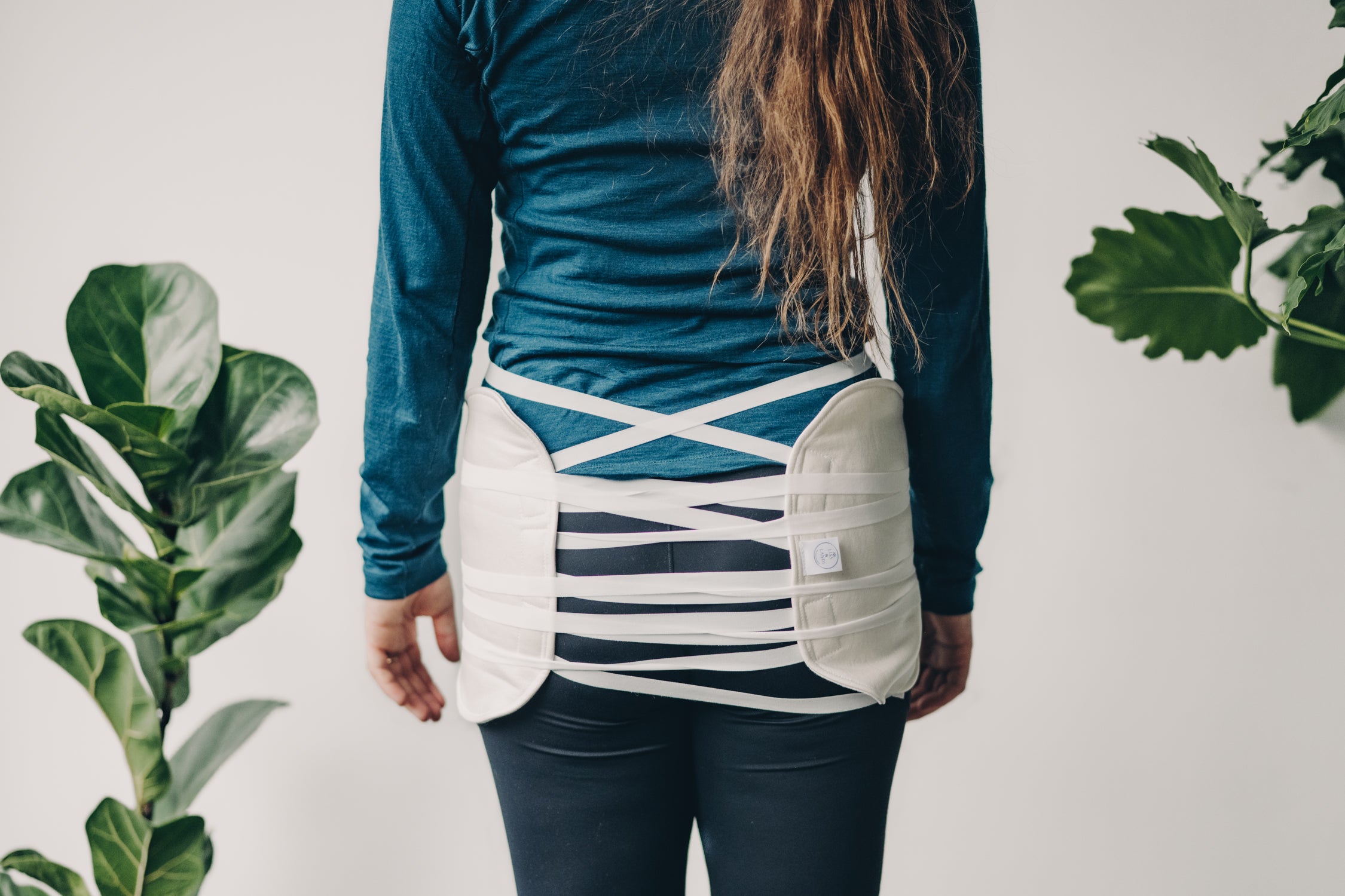 Hip Pads for Castor Oil with plants in white background
