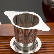 Stainless steel tea infuser on a wooden surface
