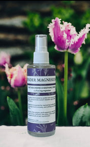 Bottle of 'Lavender Magnesium' spray with tulips in the background