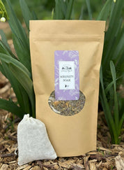 Brown package of 'Serenity Soak' with a purple label on a natural background