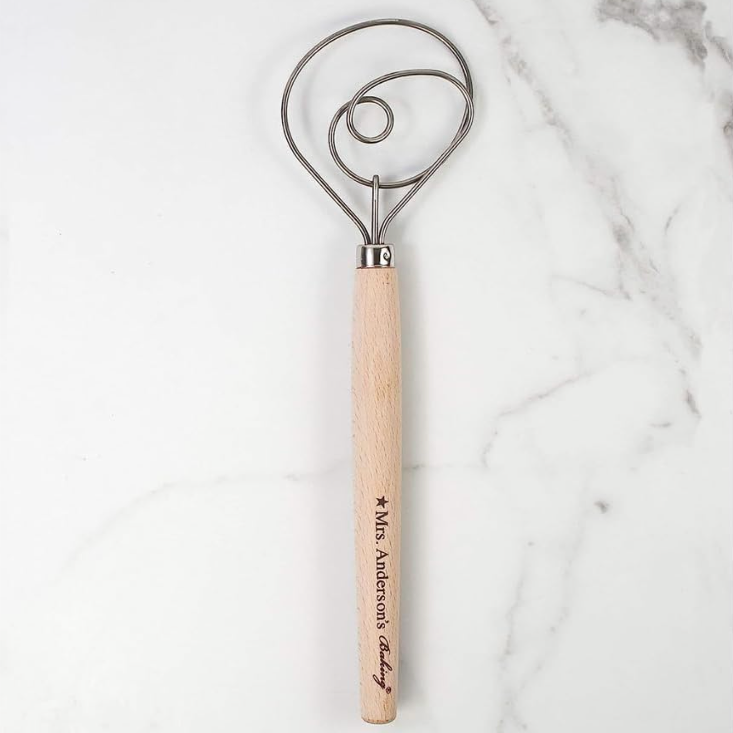 Kitchen tool with wooden handle and metal head made by Mrs. Anderson's Baking on a marble background