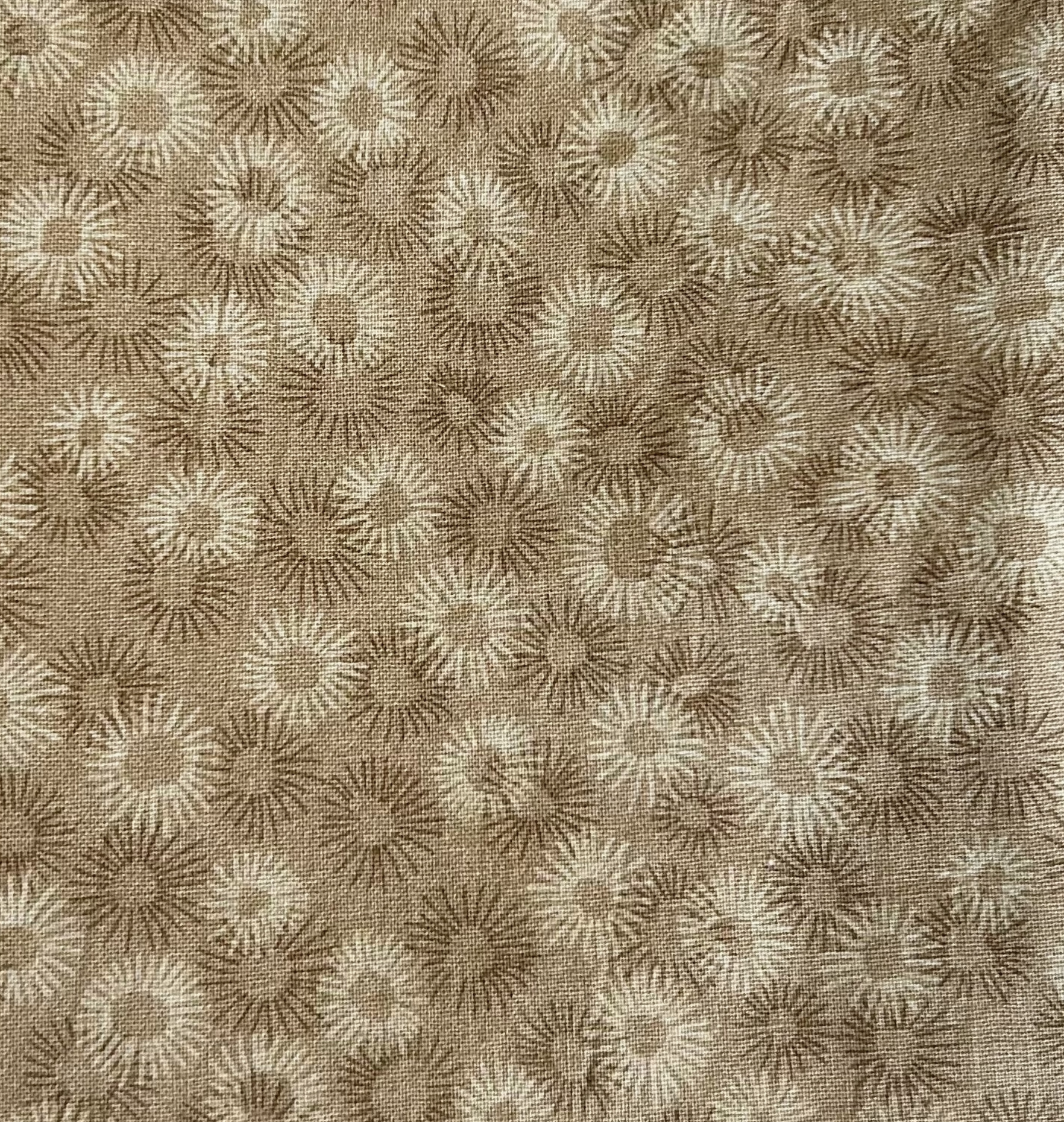 Textured fabric with a subtle pattern of geometric shapes in brown and beige.