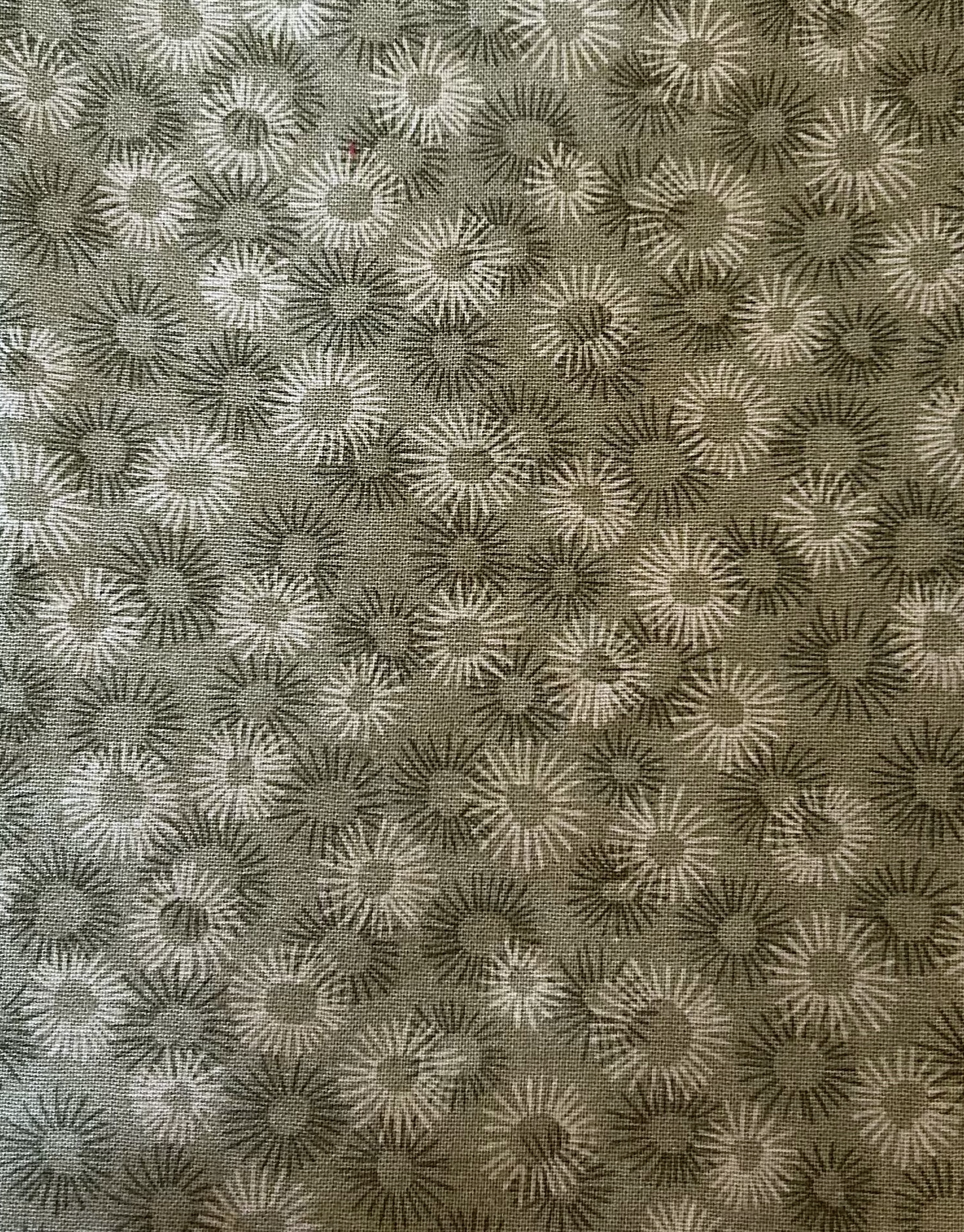 Patterned fabric with sunflower design on a brown background