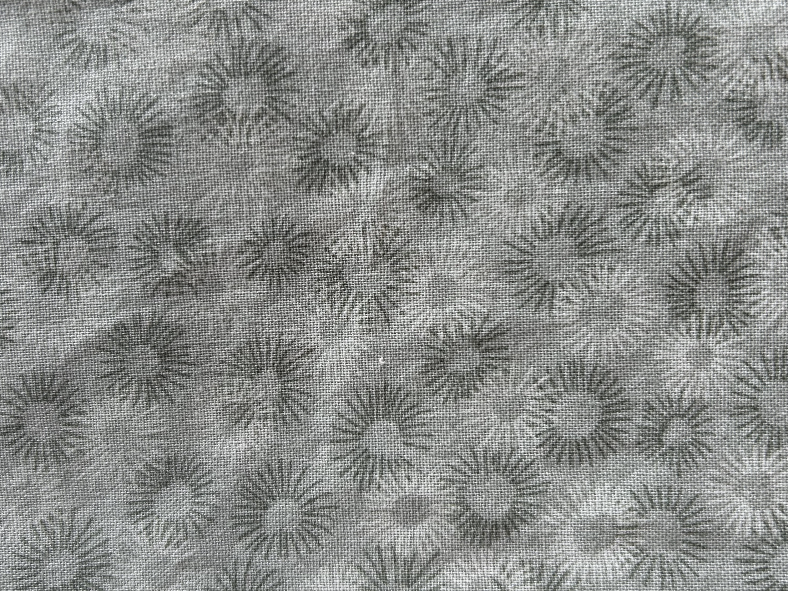 Patterned fabric with sunburst design on a gray background