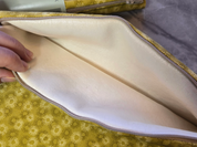 Close-up of a beige castor oil pack with a floral-patterned background